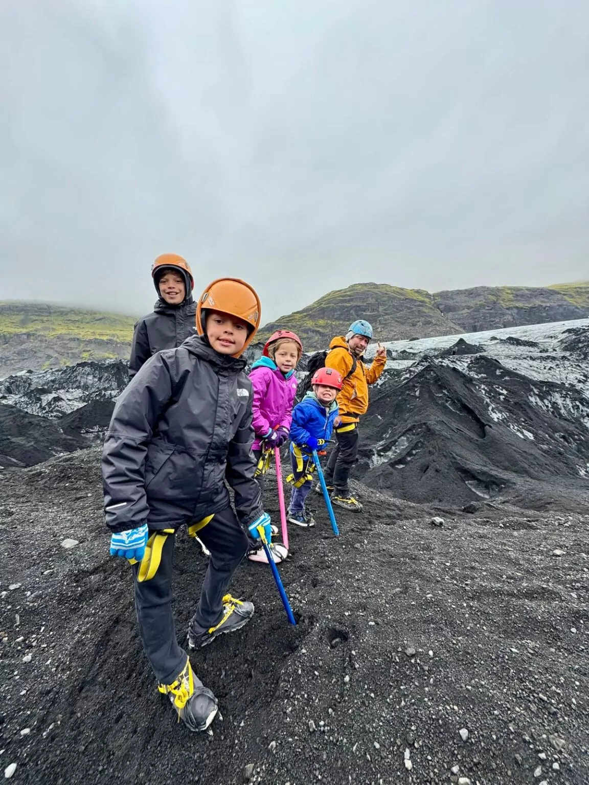 Family geared up for a glacier hike at Sólheimajökull in Iceland.
