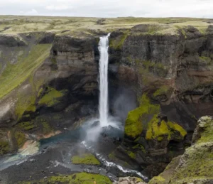 Háifoss waterfall plunging into a mossy gorge in Iceland.