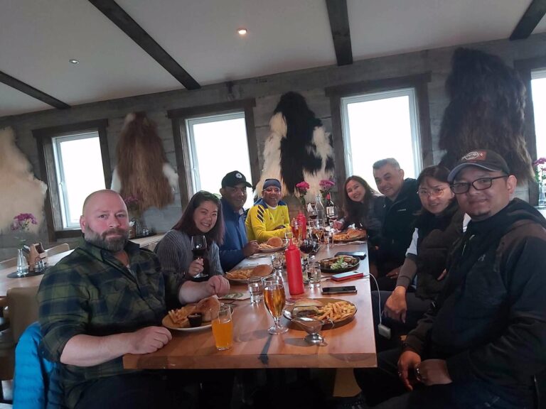 Otto the guide and guests enjoying a meal together at a cozy Icelandic restaurant.