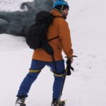 Otto, a Viking guide, hikes across snow in Iceland with an ice axe and backpack.