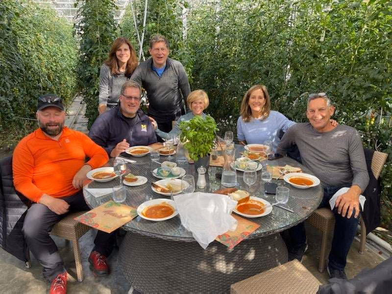 Friendly Golden Circle farm experience with Otto the Viking sharing a cozy greenhouse meal with guests.